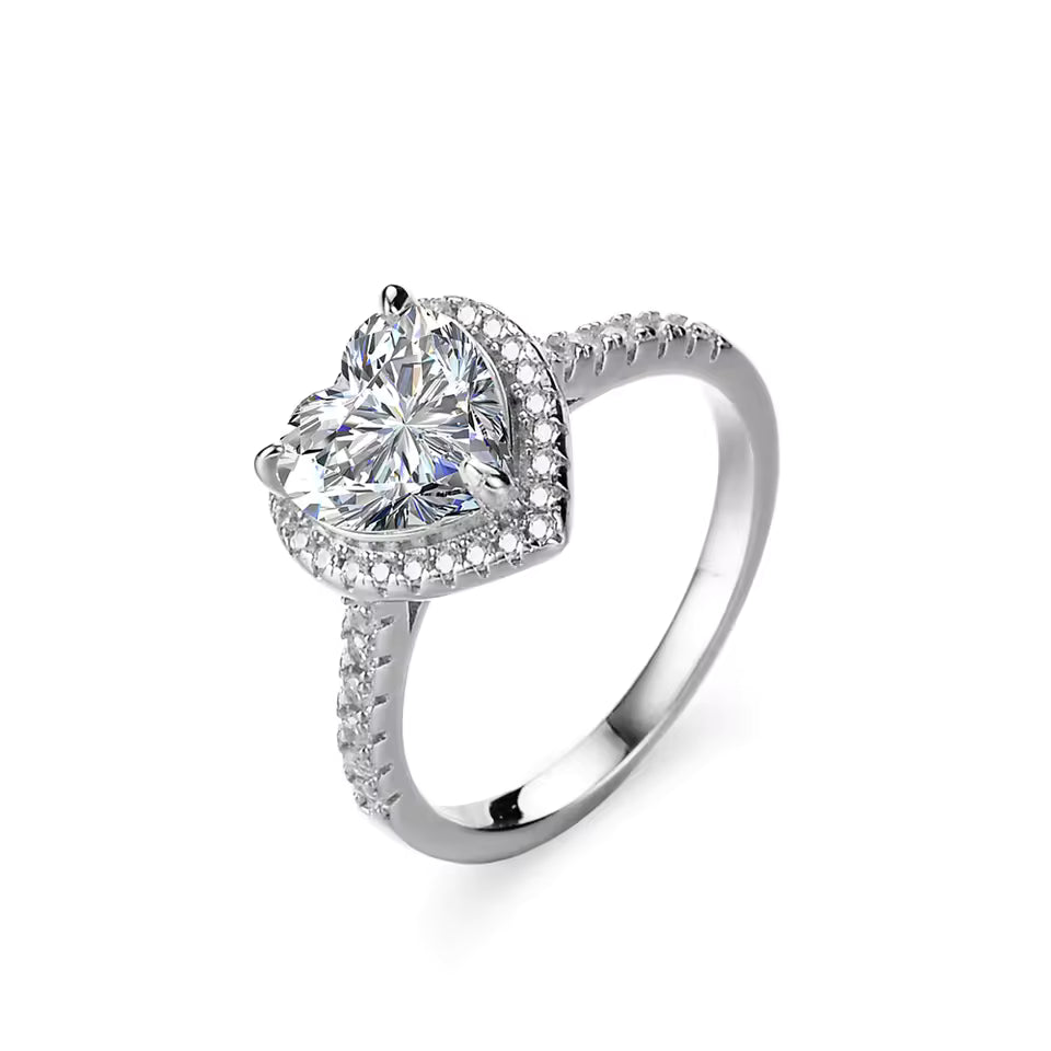 Silver ring with a large diamond and smaller diamonds on the band against a white background