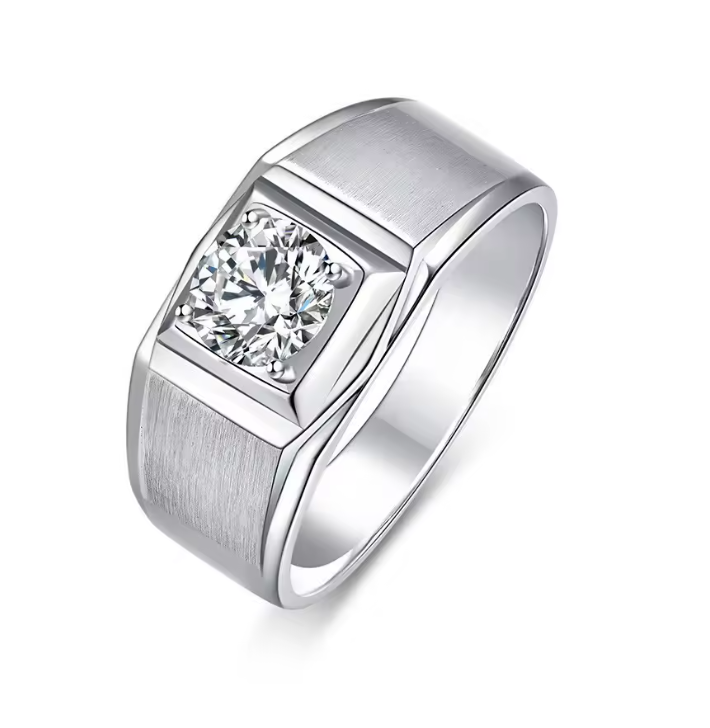A silver-toned men's ring featuring a square-cut clear gemstone in a bezel setting, with a brushed metal texture on the shoulders and a polished band, shown on a white background.
