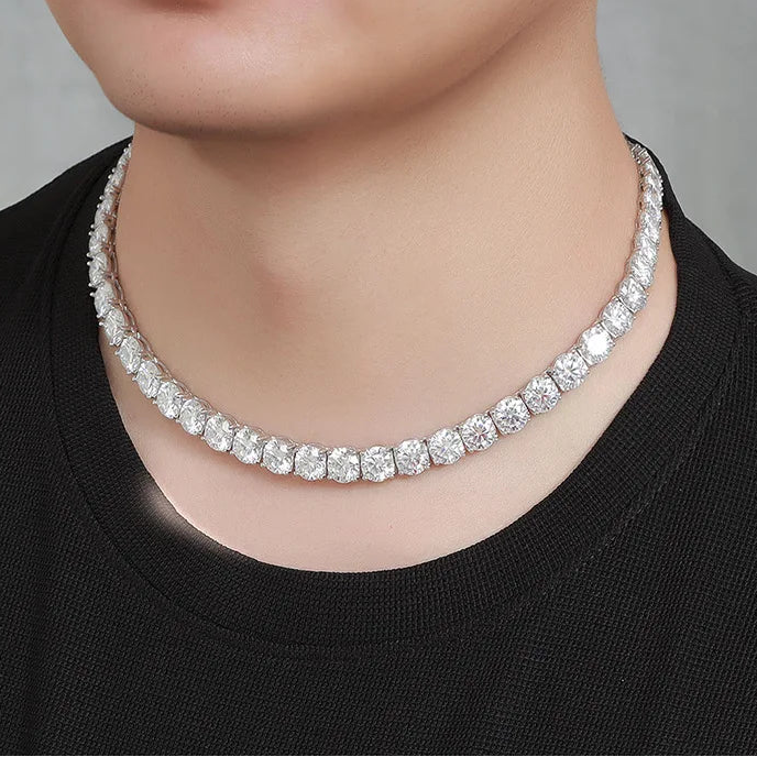 Person wearing a diamond necklace against a neutral background