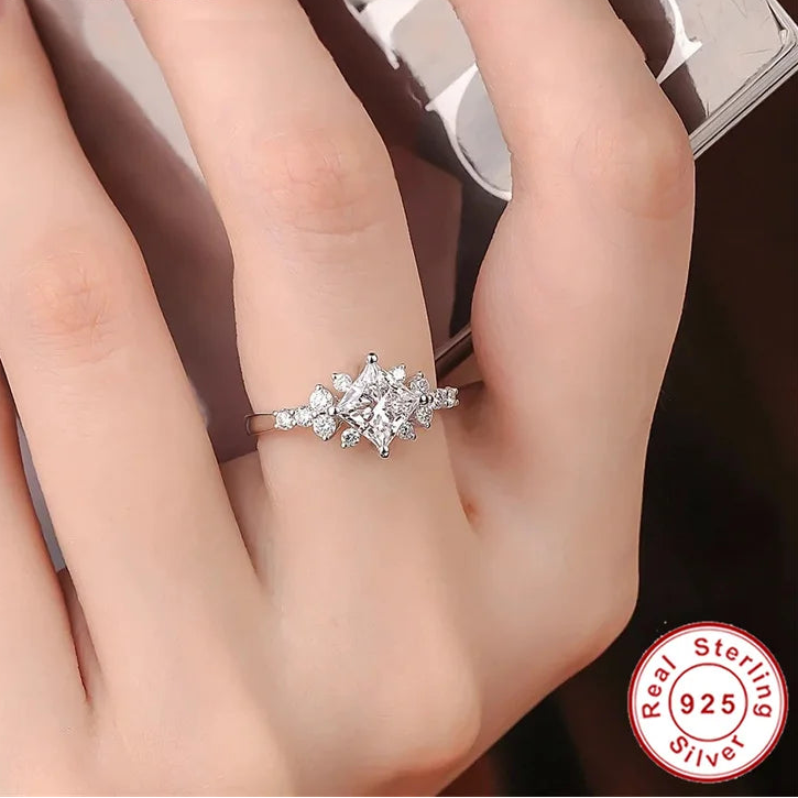 Moissanite ring on a finger with princess cut moissanite 