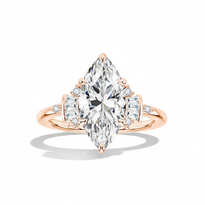 Rose gold ring with a pear-shaped diamond on a light surface