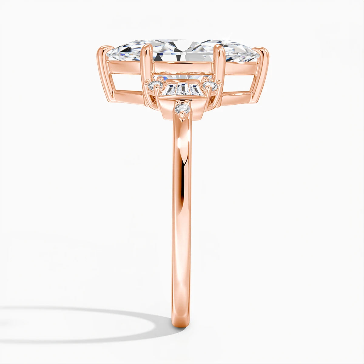 Rose gold ring with a large diamond and smaller diamonds on a white background