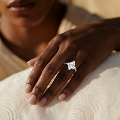 Close-up of a hand wearing a diamond ring on a textured surface