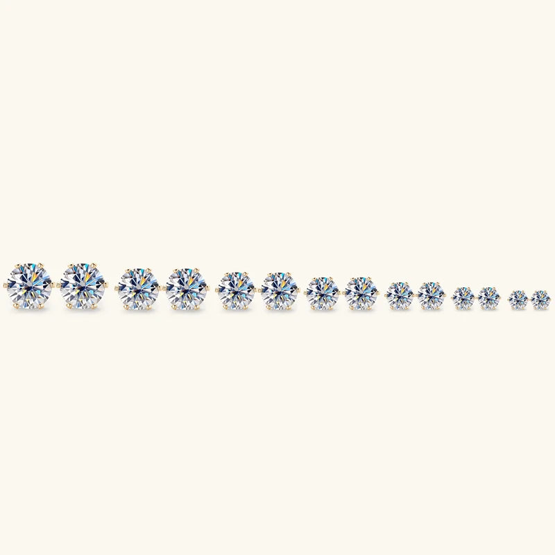 Row of diamond earrings on a white background