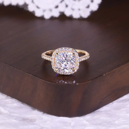 Gold ring with a large diamond on a wooden surface