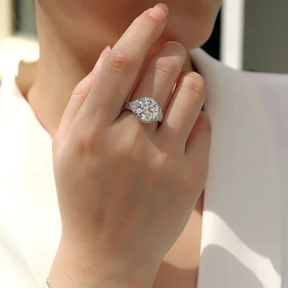 Close-up of a hand wearing a diamond ring with a blurred background
