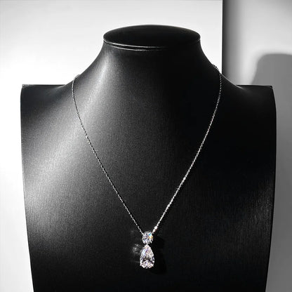 Silver necklace with a teardrop pendant on a black mannequin bust.