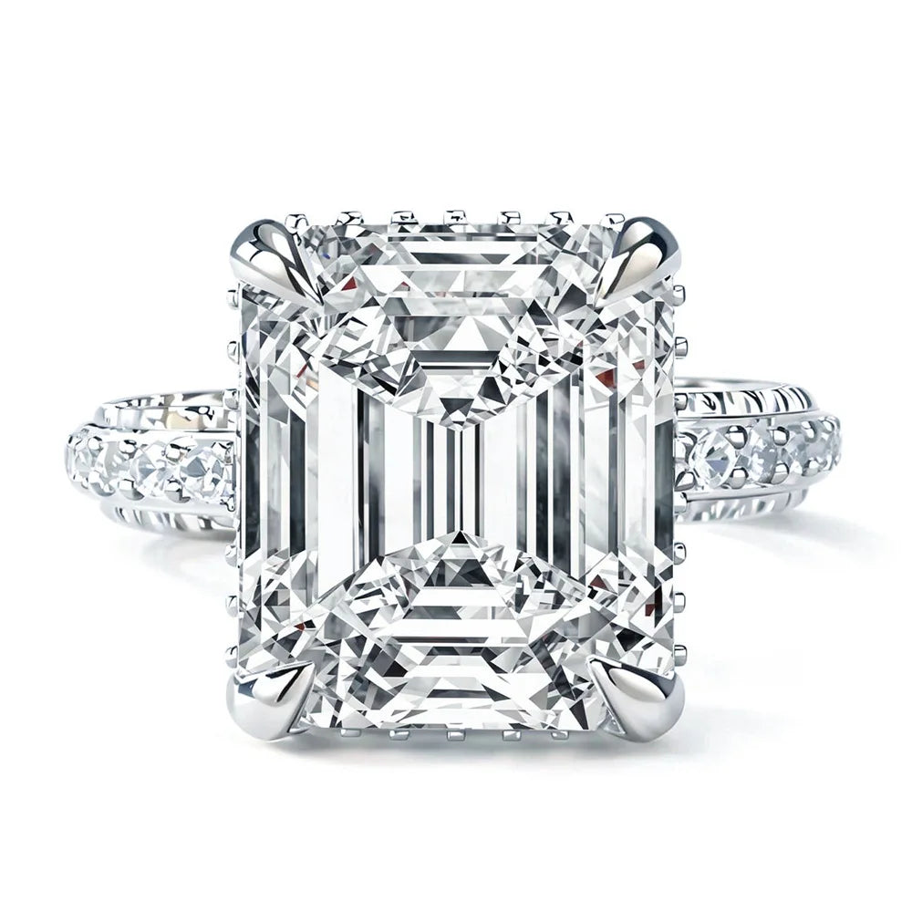 Diamond ring with emerald-cut center stone on a white background