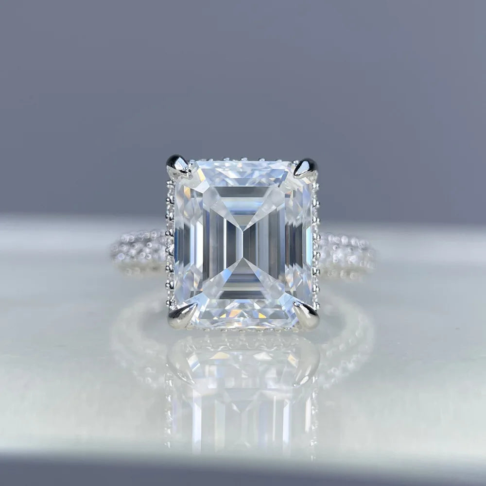 Diamond ring with a square-cut gemstone on a reflective surface