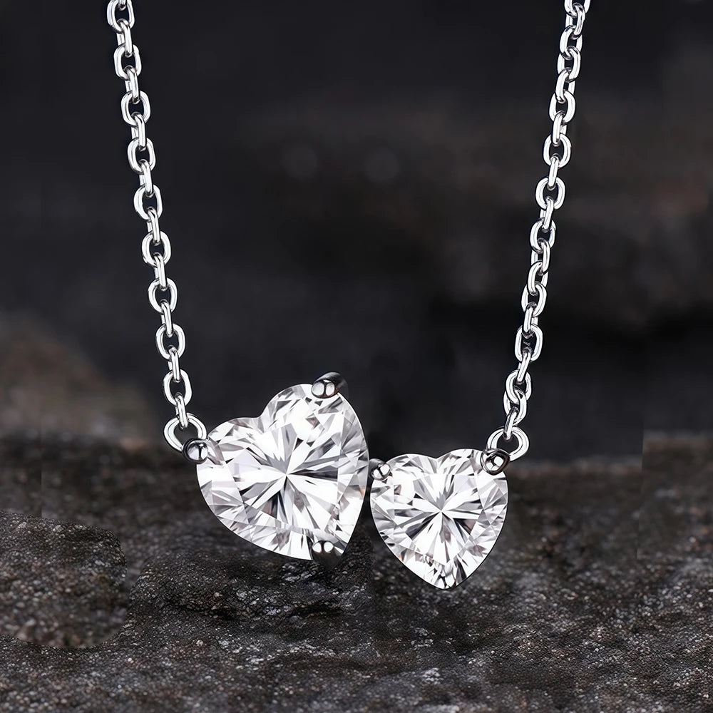 Heart-shaped diamond necklace on a dark stone surface