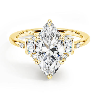 Gold ring with a large pear-shaped diamond and smaller side stones on a white background