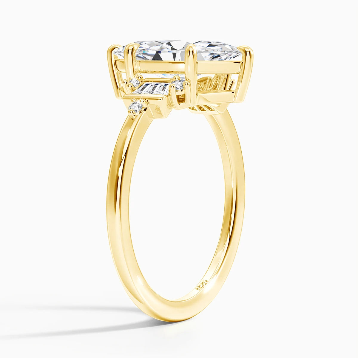 Gold ring with three diamond stones on a white background