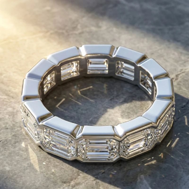 Silver ring with diamond accents on a stone surface