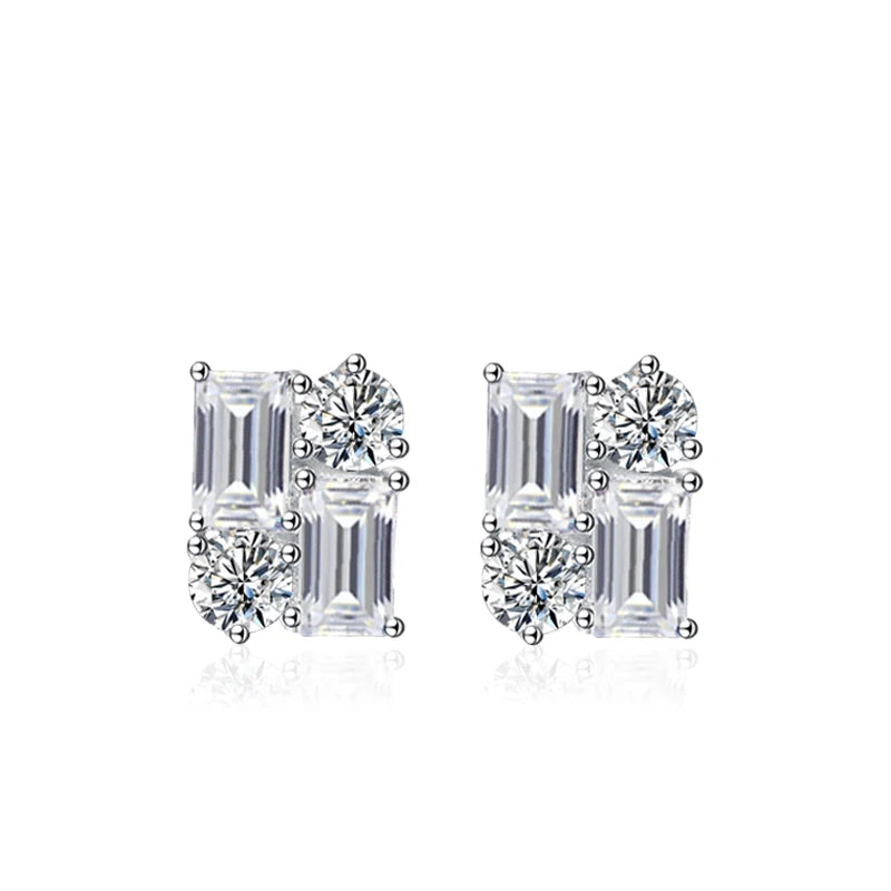 Pair of diamond earrings with emerald-cut and round-cut stones on a white background