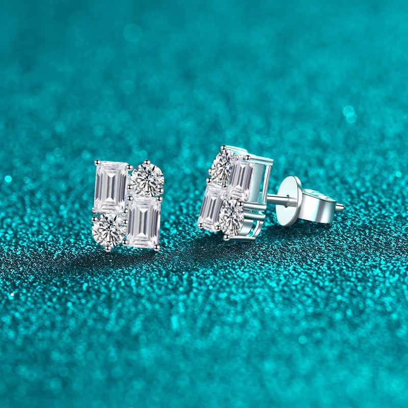 Silver earrings with gemstones on a teal glittery background