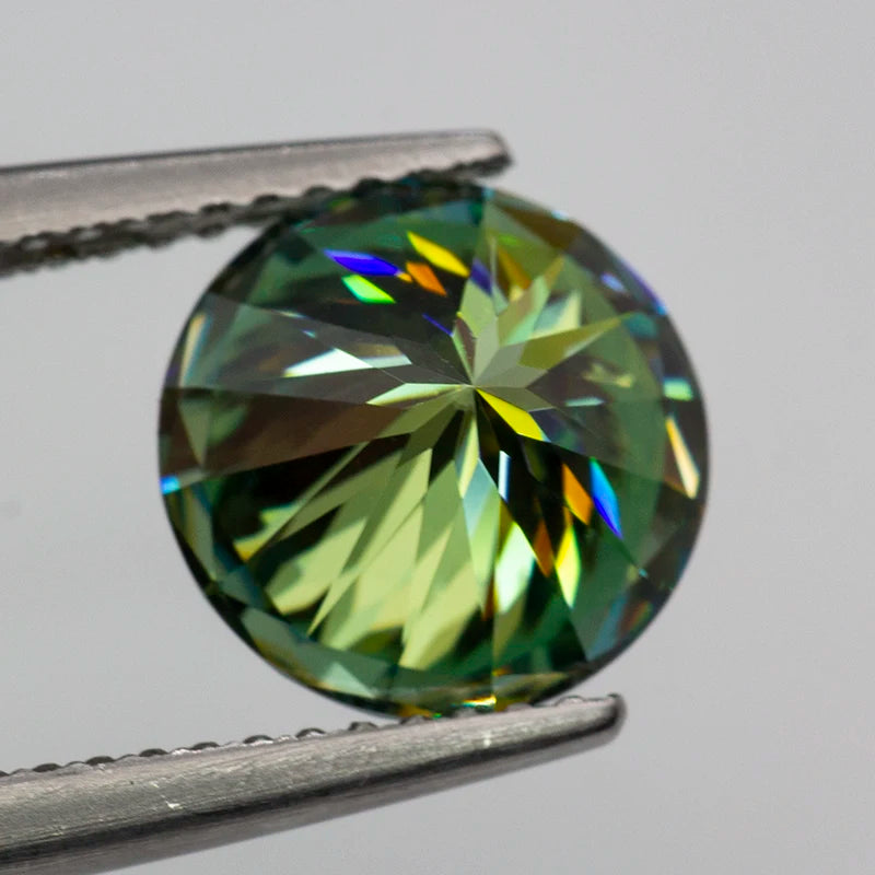 Multicolored gemstone held between tweezers on a gray background