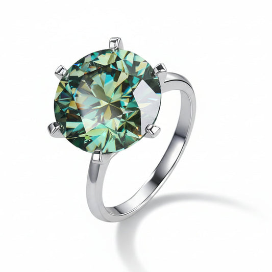 Silver ring with a green gemstone on a dark background