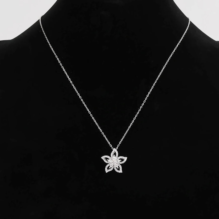 Silver necklace with a floral pendant on a black mannequin against a white background