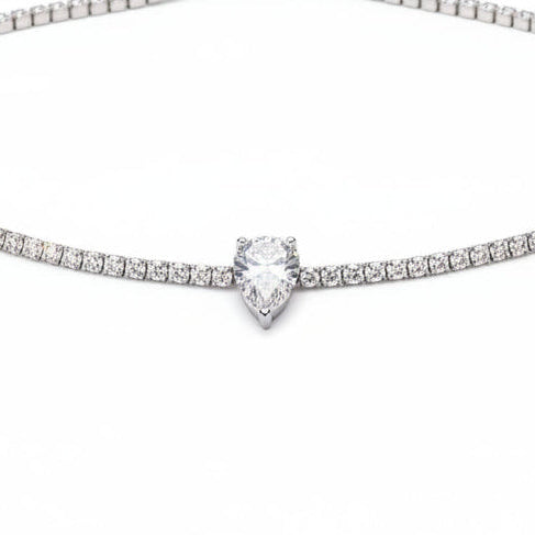 Diamond necklace on a black velvet stand with a blurred background