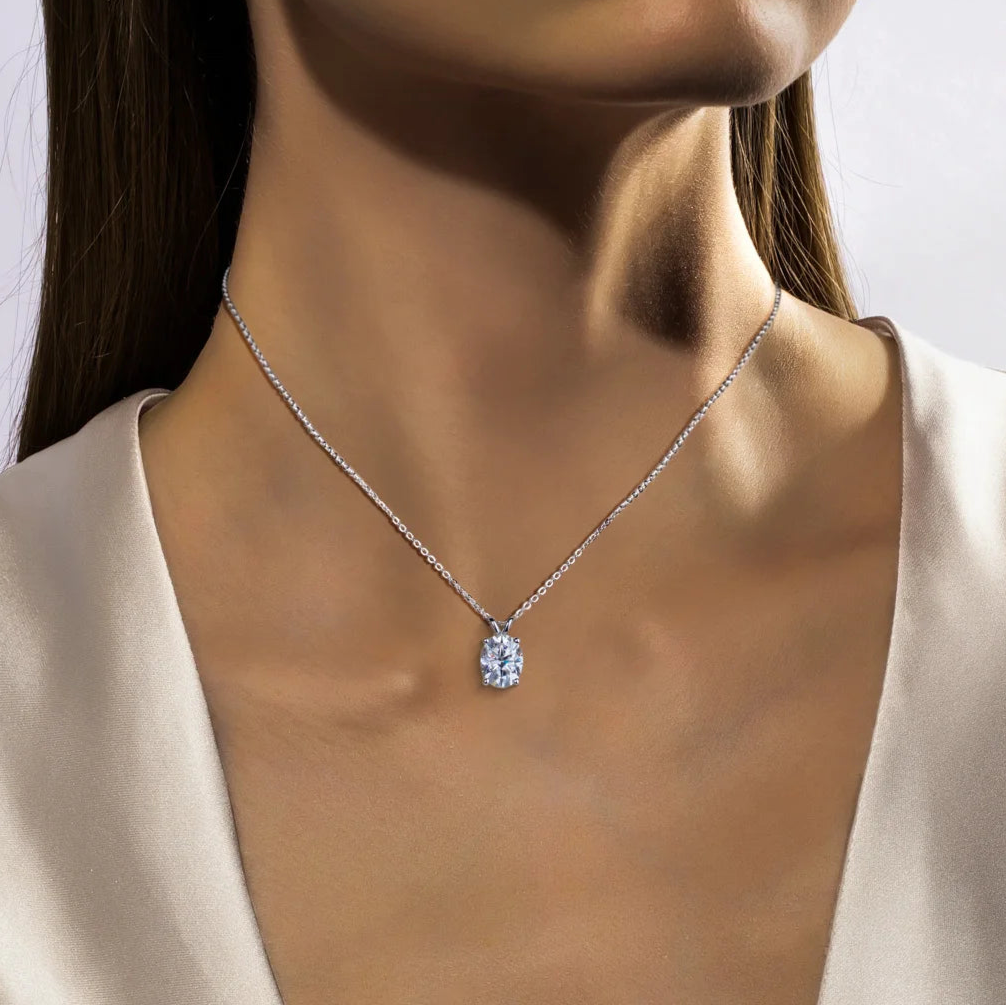 Necklace with a pendant worn by a model against a neutral background