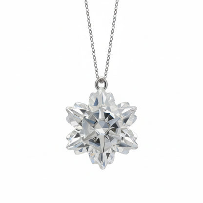 Diamond snowflake pendant on a chain against a light blue background