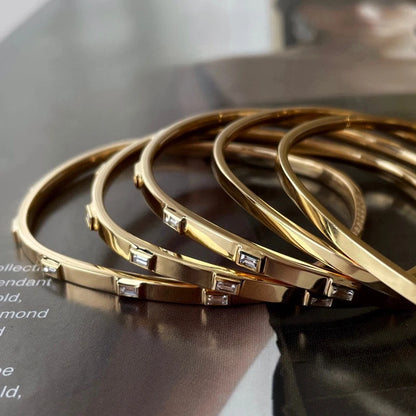 Love Design Bangle in 18K Yellow Gold with Natural Diamonds.