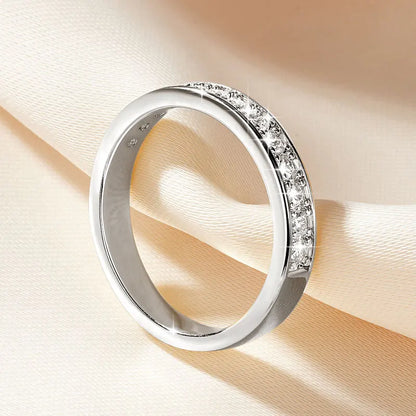 Silver ring with small diamonds on a beige background