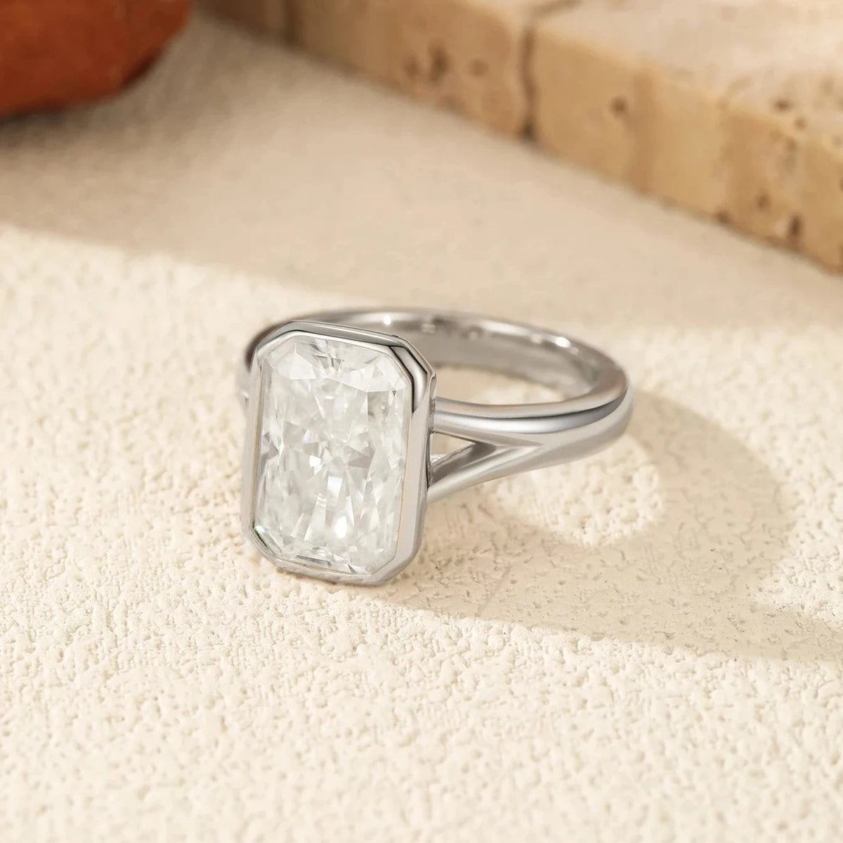 Silver ring with a large diamond on a textured surface