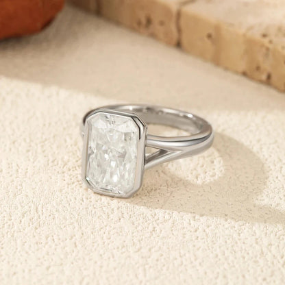 Silver ring with a large diamond on a textured surface